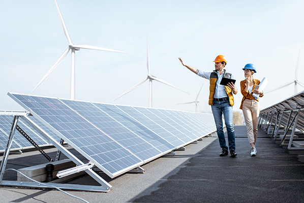 workers inspecting wind turbines