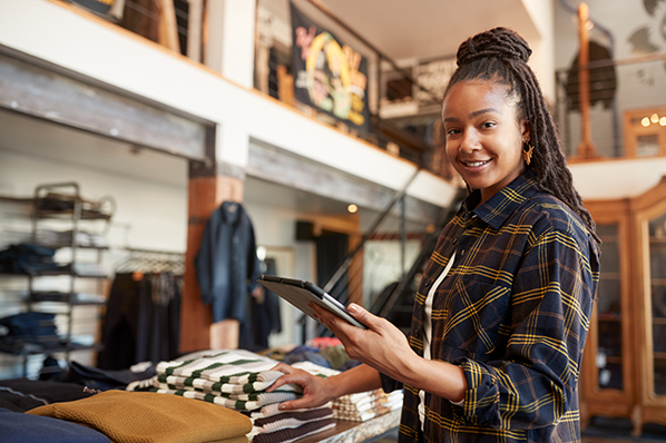 woman in a clothing store smiling