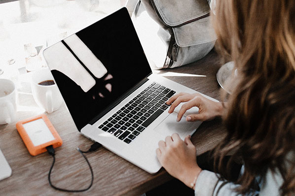 woman with laptop looking away