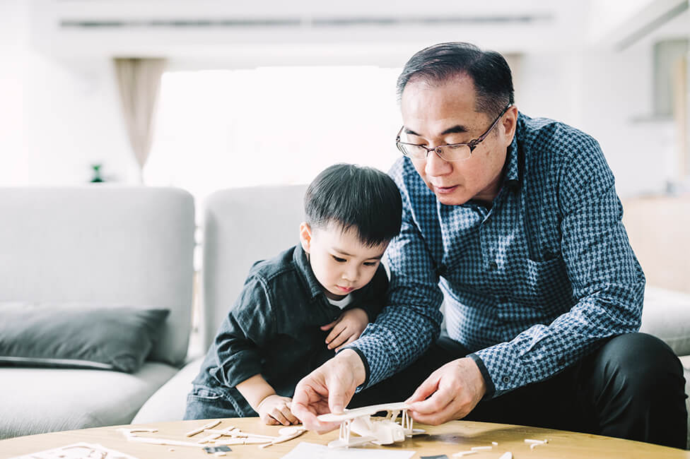 grandpa and grandson building a model airplane