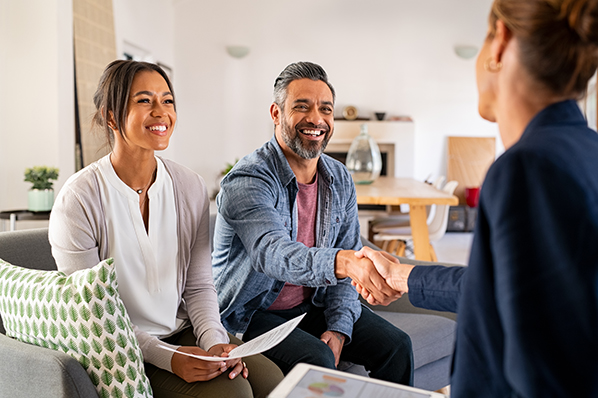 middle-aged couple sitting down with a financial advisor