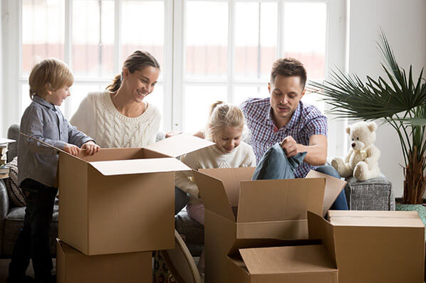 young family packing a house for a move
