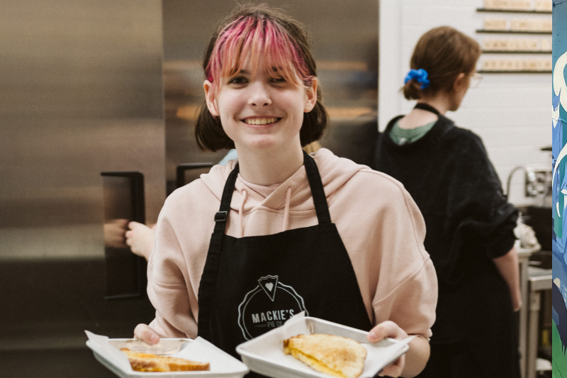 A woman holding two pies