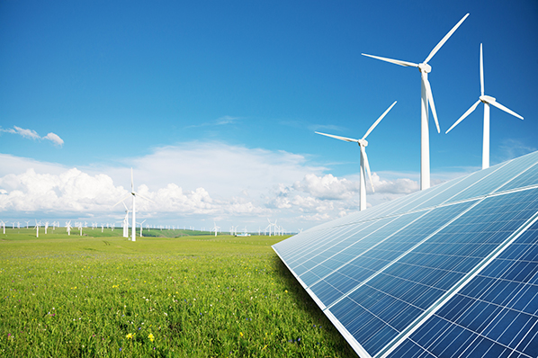 picture of modern windmills and solar panels against a green grass and blue sky