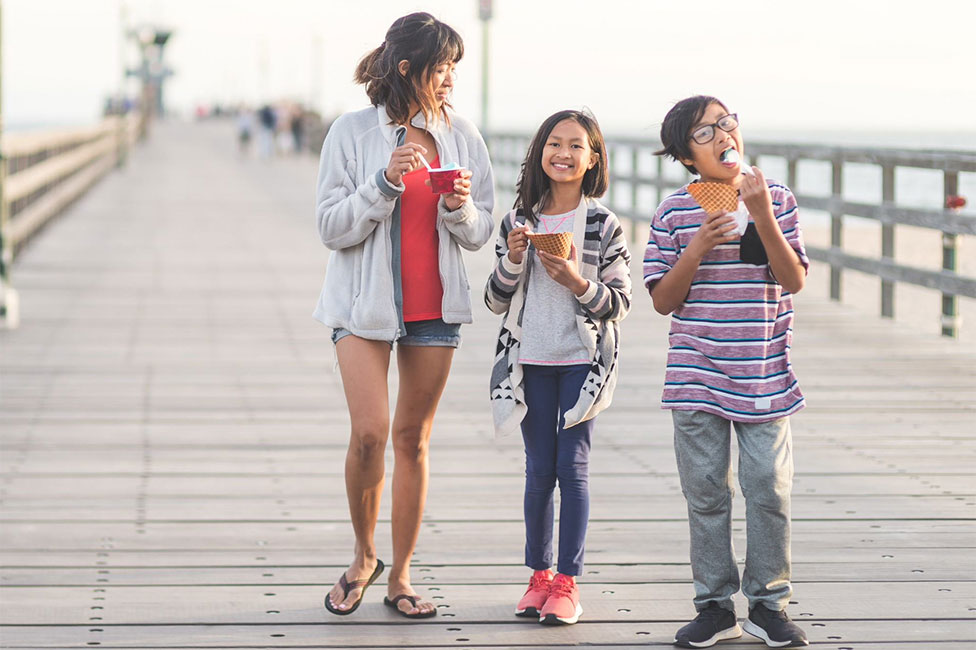 mom and kids eating ice cream on the pier