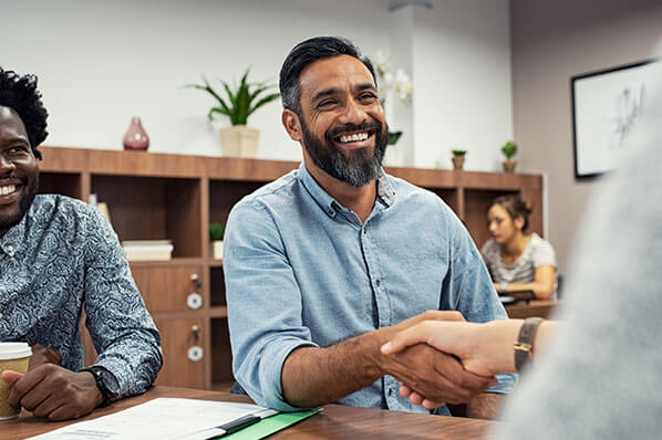 male business owner shaking hands